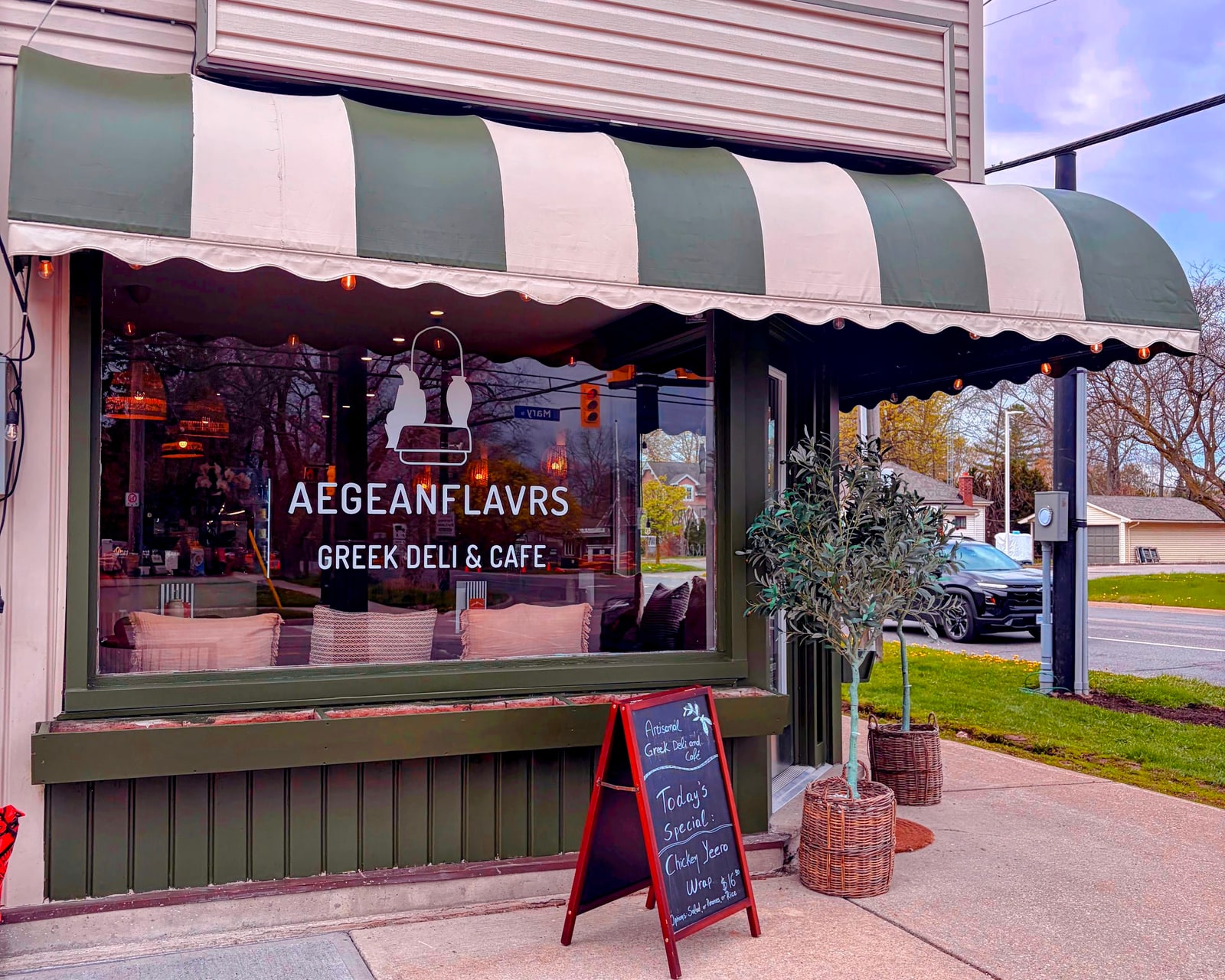 Aegean Flavours Greek Deli & Cafe storefront with a striped awning