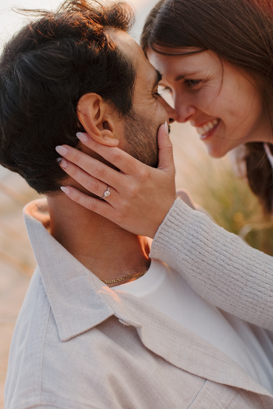 Sarah and Stephane sharing a kiss, with Sarah’s engagement ring in view.